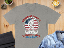 Load image into Gallery viewer, Grey t-shirt with Bigfoot and American flag celebrating the 1776-2026 Semiquincentennial.
