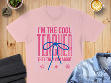 Load image into Gallery viewer, Pink t-shirt with "I'm the cool teacher" graphic and a blue bow.
