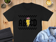 Load image into Gallery viewer, Black t-shirt with yellow lightning bolt and "ABCD" graphic.
