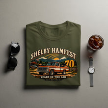 Load image into Gallery viewer, Olive green t-shirt with Shelby Hamfest graphic featuring vintage truck and mountains.
