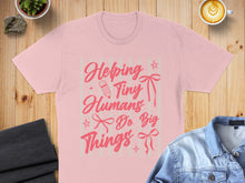 Load image into Gallery viewer, Pink t-shirt with "Helping Tiny Humans Do Big Things" text.
