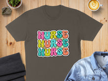Load image into Gallery viewer, Brown t-shirt with "NURSE" in colorful, retro bubble letters.

