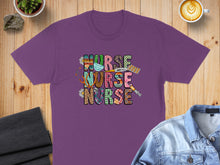 Load image into Gallery viewer, Purple t-shirt with "NURSE" text in colorful animal print patterns and medical icons.
