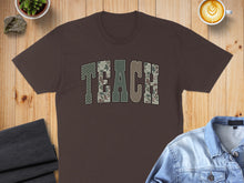 Load image into Gallery viewer, Brown t-shirt with "TEACH" in camouflage lettering.
