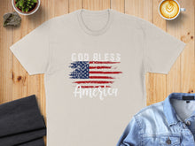 Load image into Gallery viewer, Cream t-shirt with distressed American flag and "God Bless America" text.
