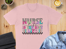 Load image into Gallery viewer, Pink t-shirt with "Nurse is the best life" graphic in colorful distressed lettering.
