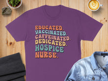 Load image into Gallery viewer, Purple t-shirt with "Educated. Caffeinated. Dedicated. Hospice Nurse." text in colorful block letters.
