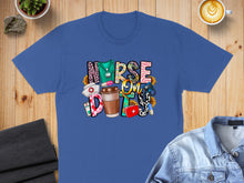 Load image into Gallery viewer, Blue t-shirt with colorful "Nurse Life" graphic featuring coffee and medical icons.
