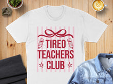 Load image into Gallery viewer, White t-shirt with "TIRED TEACHERS CLUB" text and pencil graphics.
