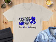 Load image into Gallery viewer, Beige t-shirt with blue leopard print peace sign, heart, and medicine bottle graphic.
