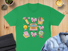 Load image into Gallery viewer, Green t-shirt with school supplies including a bus, book, globe, and crayons.
