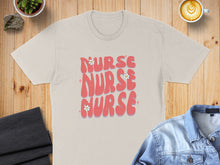 Load image into Gallery viewer, Beige t-shirt with pink "Nurse Nurse Nurse" text and flowers.
