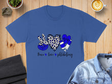 Load image into Gallery viewer, Blue t-shirt with peace, heart, and syringe graphics and "Peace love phlebotomy" text.
