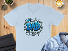 Load image into Gallery viewer, Light blue t-shirt with blue "Dad" graphic featuring words like "Funny," "Hero," and "Protector."
