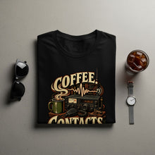 Load image into Gallery viewer, Black t-shirt with "Coffee Contacts" graphic featuring a vintage radio, mug, and microphone.
