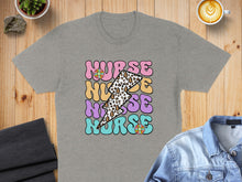 Load image into Gallery viewer, Grey t-shirt with "Nurse" in colorful, bold lettering and lightning bolt design.
