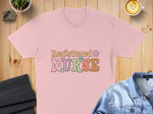 Load image into Gallery viewer, Pink t-shirt with "Registered Nurse" text in retro floral font.
