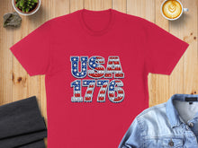 Load image into Gallery viewer, Red t-shirt with "USA 1776" text in a distressed American flag design.

