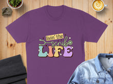 Load image into Gallery viewer, Purple t-shirt with "livin' the LIFE" text and stethoscope design.
