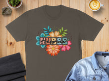 Load image into Gallery viewer, Brown t-shirt with colorful floral "NURSE" graphic and coffee cup detail.
