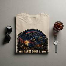 Load image into Gallery viewer, T-shirt with graphic of Earth, radio, and text "THE BANDS COME ALIVE".
