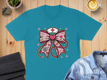 Load image into Gallery viewer, Teal t-shirt featuring a pink stethoscope bow with hearts and XOXO.
