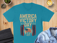 Load image into Gallery viewer, Blue t-shirt with "America Victory Day May 08" text and American flag graphic.
