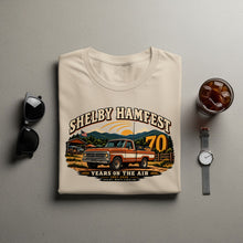 Load image into Gallery viewer, T-shirt graphic of a vintage orange pickup truck with "Shelby Hamfest 70 Years on the Air" text.
