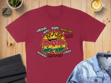 Load image into Gallery viewer, Red t-shirt with "DAD" in large letters, surrounded by words and colors of the Pan-African flag.
