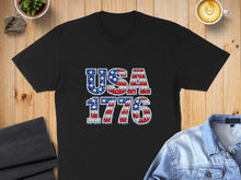 Load image into Gallery viewer, Black t-shirt with "USA 1776" in red, white, and blue mosaic pattern.
