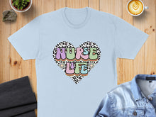 Load image into Gallery viewer, Light blue t-shirt with "Nurse Life" in a leopard print heart graphic.
