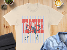 Load image into Gallery viewer, Cream t-shirt with "TEACHER" text and blue ribbon graphic.
