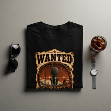 Load image into Gallery viewer, Black t-shirt with a "WANTED" graphic featuring a vintage microphone in a desert landscape.
