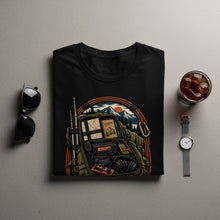 Load image into Gallery viewer, Black t-shirt with backpack graphic featuring radio, map, and mountains.
