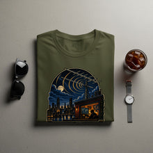 Load image into Gallery viewer, Green t-shirt with a nighttime city skyline and radio antenna graphic.
