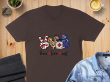 Load image into Gallery viewer, Brown t-shirt with peace sign, heart, and EMT badge graphic.
