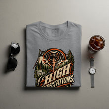 Load image into Gallery viewer, Grey t-shirt with "LOW POWER. HIGH EXPECTATIONS." graphic of mountains and signal waves.
