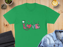 Load image into Gallery viewer, Green t-shirt with stethoscope, heart, syringe, and pills graphic.
