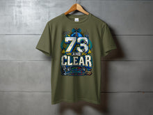 Load image into Gallery viewer, Green t-shirt with graphic design featuring "73 AND CLEAR," radio equipment, and globe.
