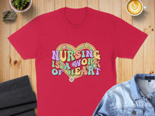 Load image into Gallery viewer, Red t-shirt with colorful groovy text "NURSING IS A WORK OF HEART" and flowers.
