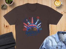 Load image into Gallery viewer, Brown t-shirt with graphic of Statue of Liberty crown and "America" text.
