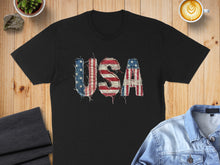 Load image into Gallery viewer, Black t-shirt with distressed "USA" graphic in American flag pattern.
