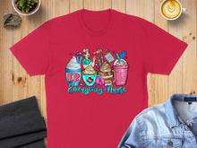 Load image into Gallery viewer, Red t-shirt with cartoon emergency nurses and coffee drinks.
