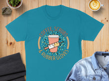 Load image into Gallery viewer, Teal t-shirt with "Coffee, Scrubs &amp; Rubber Gloves" text and medical icons.
