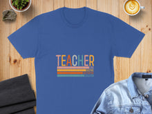 Load image into Gallery viewer, Blue t-shirt with "TEACHER" text and inspirational words in stripes.

