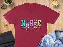 Load image into Gallery viewer, Maroon t-shirt with "Nurse Life" text and stethoscope graphic.
