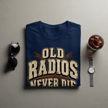 Load image into Gallery viewer, Navy t-shirt with distressed text that reads "OLD RADIOS NEVER DIE".

