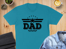 Load image into Gallery viewer, Turquoise t-shirt with black "DAD" text and star graphic, laid flat.
