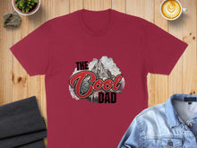 Load image into Gallery viewer, Maroon t-shirt with "The Cool Dad" text and mountain graphic.
