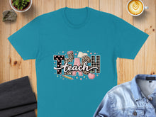 Load image into Gallery viewer, Teal t-shirt with "TEACH" text design featuring leopard print and plaid.
